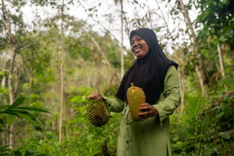 Local conservationist holding fruit in the forest