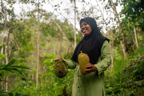 Local conservationist holding fruit in the forest